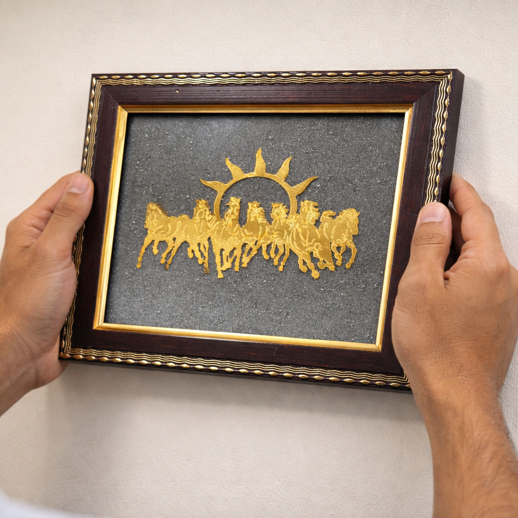 Pyrite 7 Horses Frame in Hands with gold silhouette of seven horses crafted from raw pyrite in the background.