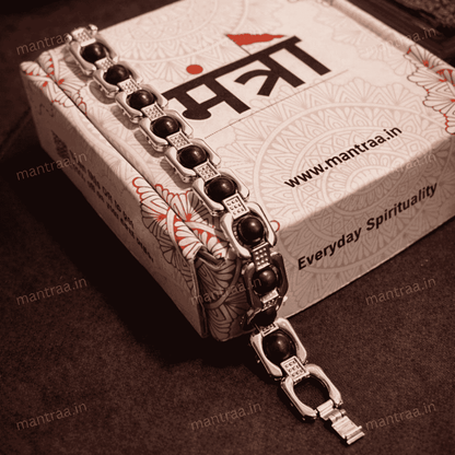 Silver bracelet with karungali beads on a branded mantraa box
